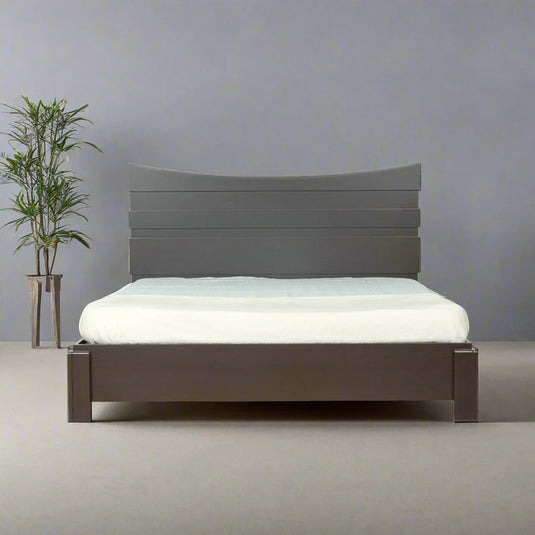 a bedframe in copper bedroom set with white mattress on it and a plant in a bedroom