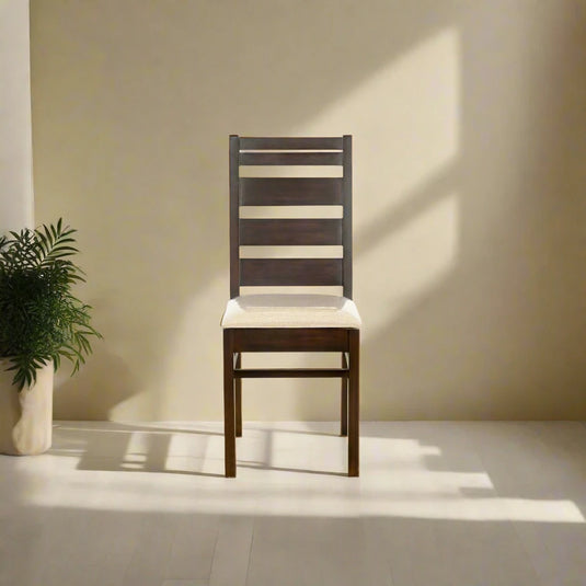 a brown color chair with white cushion on it and a plant both on a living room