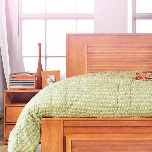 Kerala style wooden cot with a mattress in it, a wooden side box near 