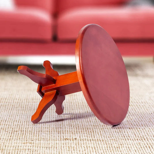 round coffee table on a floor with a sofa in background